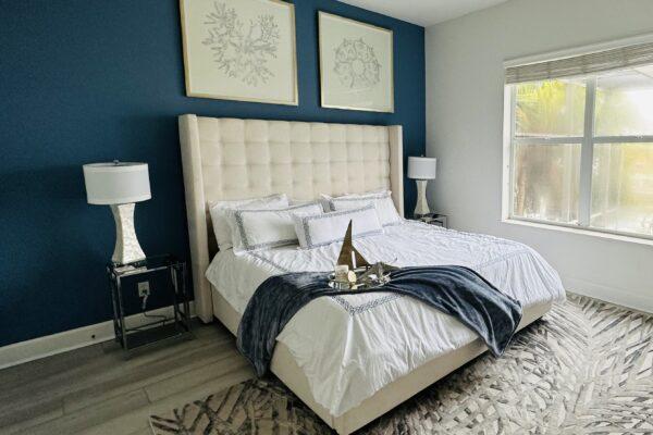 Primary bedroom naples Florida accent wall king bed High head board LVT flooring custom art work