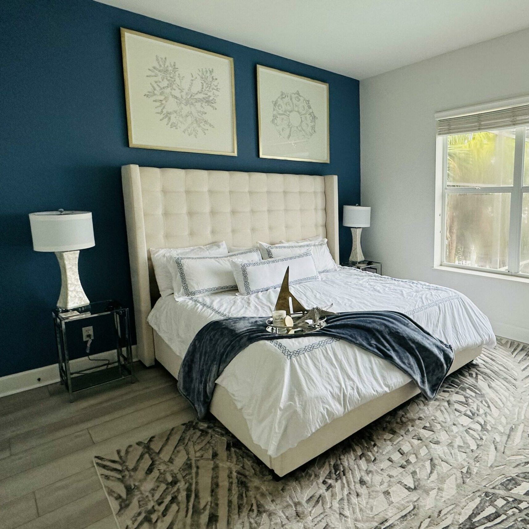 Primary bedroom naples Florida accent wall king bed High head board LVT flooring custom art work Primary bedroom naples Florida accent wall king bed High head board LVT flooring custom art work